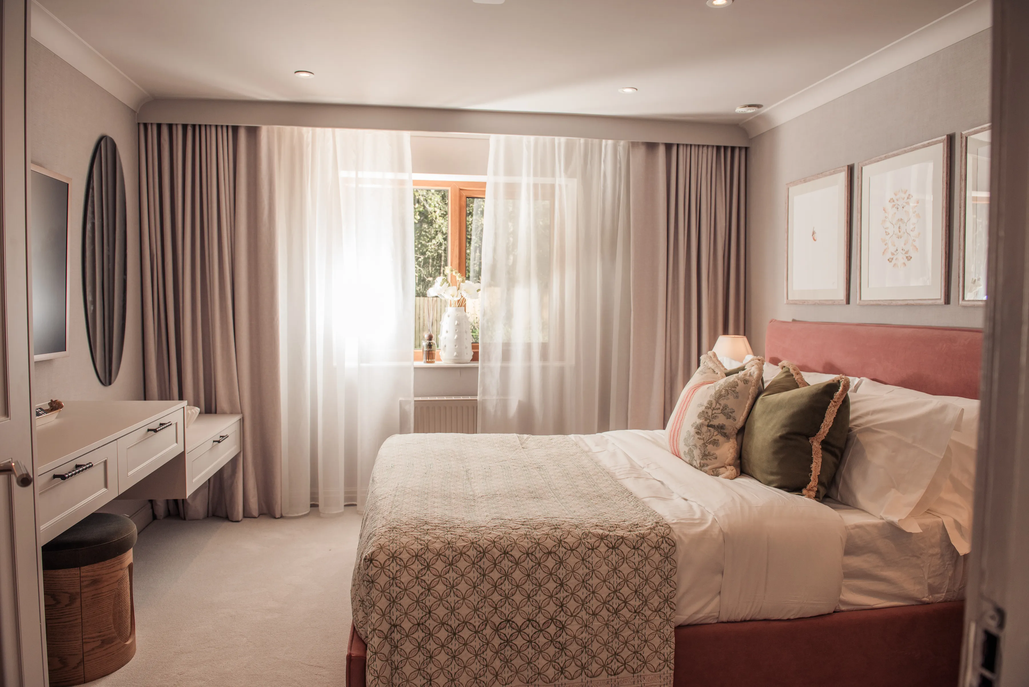 A bedroom with a bed, dresser and window.